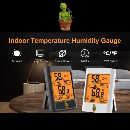 Two digital temperature and humidity gauges on a wooden surface with a plant in the background.